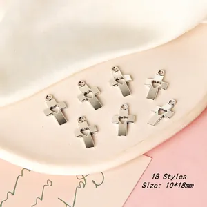 Detailed view of silver cross charms with hollow heart design measuring 10x18mm