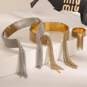 Detail of gold and silver tassel fringe bangles and ring set on white steps