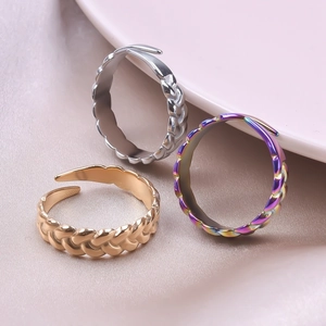 Detailed view of woven texture adjustable rings in silver, gold, and rainbow finishes