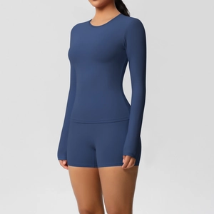 Detail of navy blue high-stretch yoga set with long sleeve top and athletic shorts
