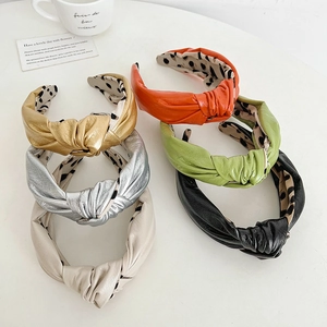 Fashionable knotted faux leather headbands in six colors with polka dot inner lining