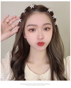 Detail of floral pearl hair clips on model showcasing 2025 elegant hairstyle look