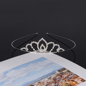 Exquisite silver bridal tiara with rhinestones on a book with city landscape cover