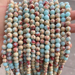 Macro shot of 8mm sea sediment jasper beads with blue and red marble textures
