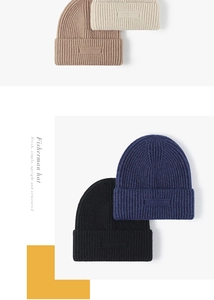 Close-up of ribbed knit texture on fisherman hats in black, blue, tan and cream colors