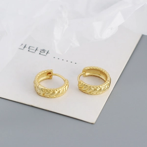 Detail of s925 gold twisted rope hoop earrings showing 925 hallmark and metal texture