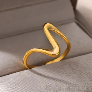 Close-up of wavy gold adjustable open ring showcasing satin finish inside jewelry box