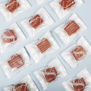 Detail of square makeup sponges in independent packaging on a light blue background