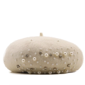 Detail shot of elegant cream wool beret featuring delicate white pearls and sparkling rhinestones