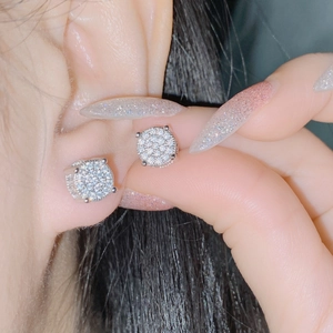 Close-up of geometric cluster stud earrings with sparkling pavé micro zircons
