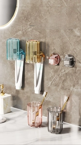 Detail view of four-color wall-mounted toothbrush holders with vertical stripe cups