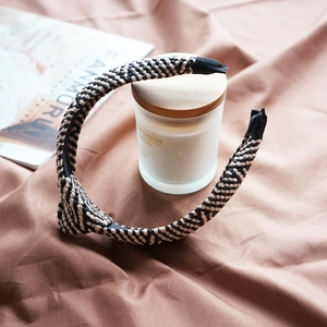 Close-up of black and white woven knotted headband with premium fabric edge details