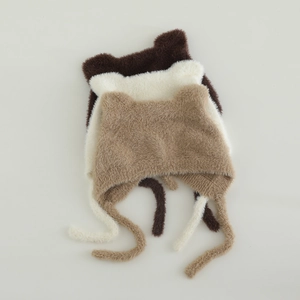 Flat lay of baby plush winter hats with cute animal ears and soft earflaps in three colors