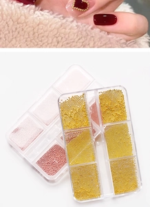 Macro detail of mixed gold and rose gold mini metal caviar beads for 3D nail art decoration