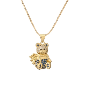 Minimalist gold-plated teddy bear necklace with blue and white stones on a box chain