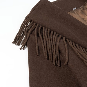 Vue détaillée d'un manteau en laine marron foncé avec franges et doublure brillante