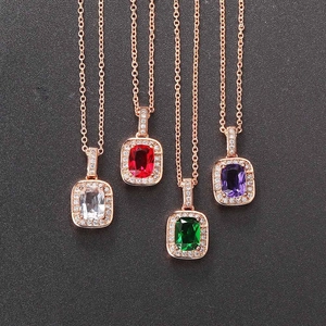 Detailed macro view of colorful geometric square zircon pendants in rose gold finish