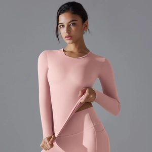 Detail of pink long-sleeve yoga top and leggings with high-stretch brushed fabric texture