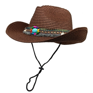 Detail of brown straw cowboy hat featuring ethnic beads, turquoise and tassels
