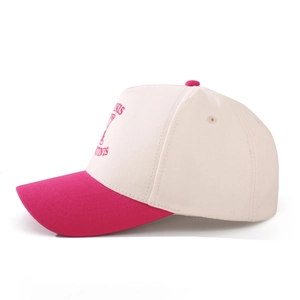 Detail of embroidered Martini glass and text on a beige and magenta baseball cap