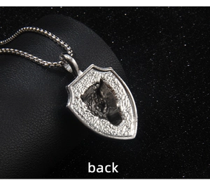 Macro detail of the textured back of a shield lion pendant with ancient silver finish