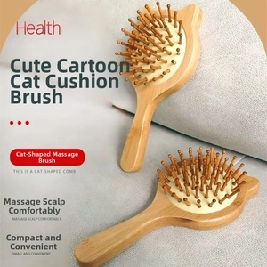 Detailed view of the cat-shaped bamboo hair brush with scalp massage air cushion