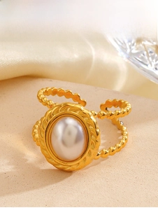Macro view of vintage 18K gold plated ring featuring oval pearl and twisted bezel details