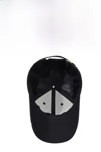 Detail view of the breathable inner lining and adjustable metal buckle of the black cap