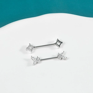 Stainless steel nipple rings with square and butterfly zircon on a white display tray