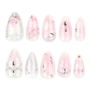 Pink rose press-on nails with long almond shape, blush gradient, pearls, and bows