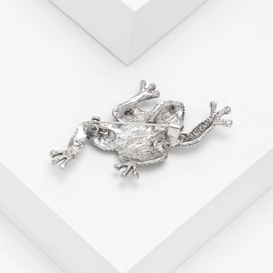 Back view of vintage silver frog brooch with abalone shell showing the pin fastener
