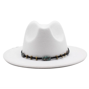 Close-up of white wide brim fedora hat featuring black braided band and turquoise beads