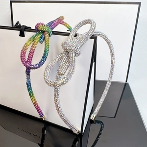 Sparkly rhinestone headband with knot bow design in rainbow and silver colors