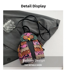 Detailed view of owl-shaped crossbody bag with layered textures and snake-print accents