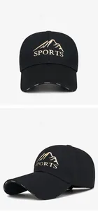 Detail of black sports baseball cap featuring golden mountain embroidery and long brim