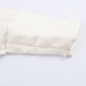 Elegant white satin blouse featuring a refined sleeve cuff with a subtle hidden zipper