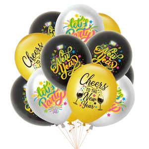 Close-up of gold, black, and white New Year balloons with festive Cheers and Party prints