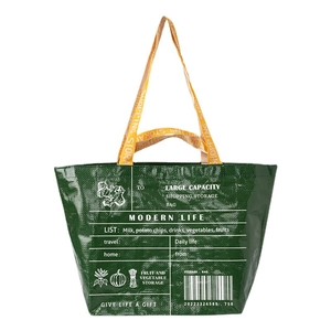 Green foldable shopping bag with yellow handles and modern graphic print on white background
