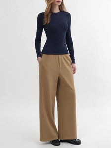 Slim fit navy long sleeve top paired with khaki wide leg trousers and black loafers