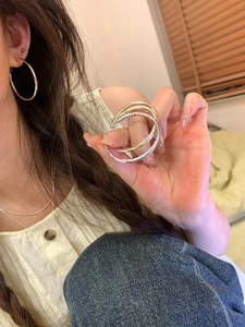Close-up of classic silver and gold hoop earrings with smooth geometric metallic finish