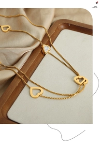 Detailed view of gold plated heart pendant necklace with shimmering zircon pavé stones