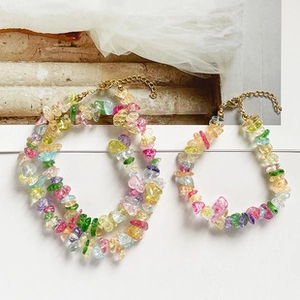 Detail view of Bohemian colorful crushed stone necklace and bracelet set with gold clasp
