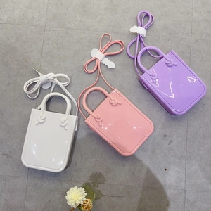Detailed top view of PVC jelly bags in white, pink, and purple with matching straps