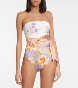 Detail of strapless one-piece swimsuit featuring floral patchwork and side cut-out tie