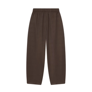 Detailed flat lay of dark brown wide-leg trousers with elastic waist and vertical seam