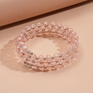 Detailed macro view of pink glass beaded wrap bracelet with rhinestone metal spacers
