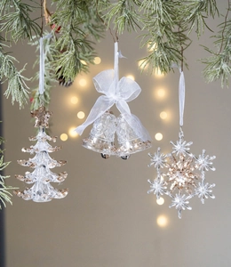 Sparkling acrylic Christmas ornaments set with snowflake and bell hanging on tree
