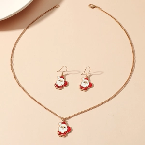 Detail of Christmas jewelry set with gold Santa Claus necklace and matching earrings