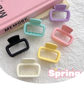 Macro detail of six rectangular matte hair claws in vibrant pastel macaron colors