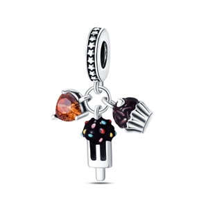 Macro detail of chocolate cake and popsicle silver charms with orange heart zircon stone